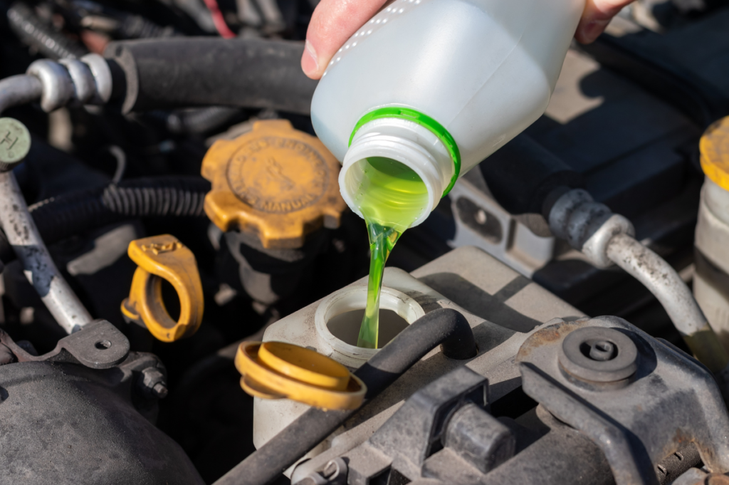 A Mobile mechanic in Liverpool pours windscreen washer fluid into the engine.
